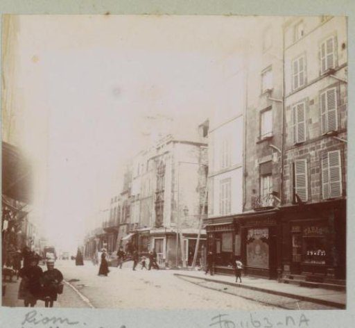 Street in Riom with shops and passersby