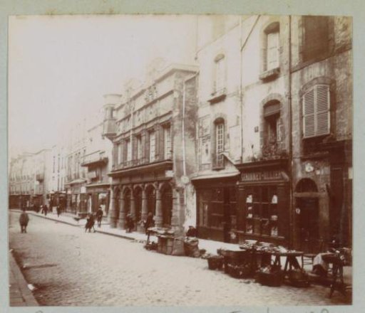 Street in Riom with shops and passersby