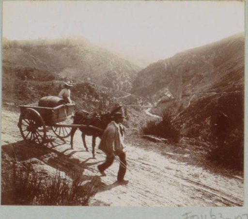 Man and woman with horse and wagon on a country road, presumably in the Auvergne