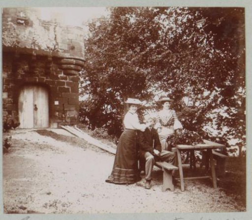 Two women and a man at the ruins of the Castle of Tournoël near Volvic