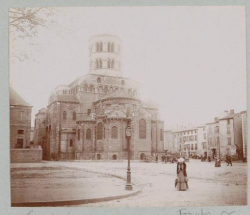 View of the Church of Sainte-Austremoine in Issoire with passers-by and an automobile