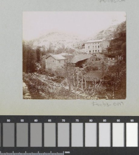 Houses against a mountainside, probably in the Auvergne