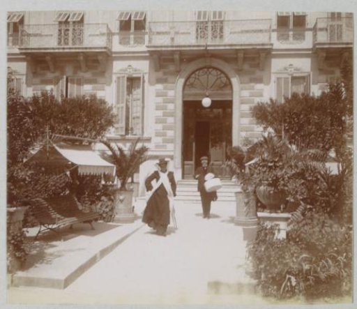Man and Woman with Luggage in Front of a Building in Nice