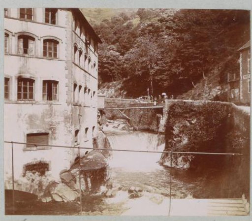 Houses, bridge and waterfall in Thiers