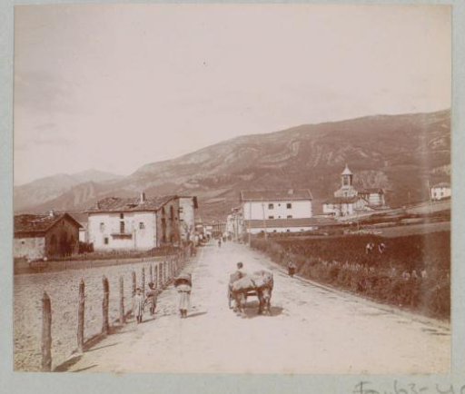 Country road with children and an ox cart, with a village in the background, presumably in the Spanish Basque Country