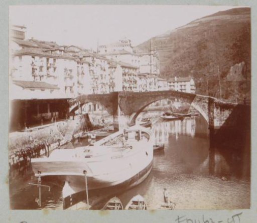 View of a town with a bridge, harbour and ships, possibly in the French or Spanish Basque Country