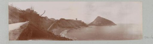 View of a mountainous coast with a peninsula and a church, probably in the French or Spanish Basque Country