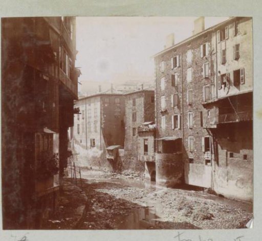 Houses along a dried-up riverbed in Annonay