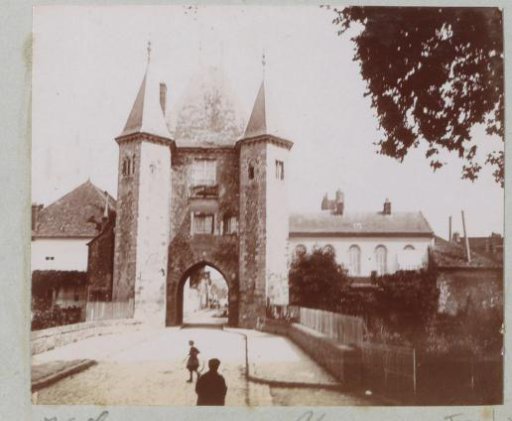 View of a city gate in Villeneuve-sur-Yonne, with (possibly) the photographer's shadow in the foreground