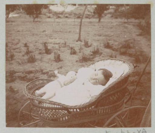 Portrait of a sleeping baby in a pram, probably in France