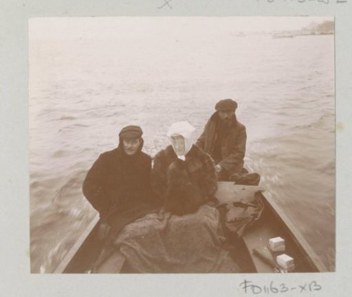Two men and a woman in a boat, probably in France during a hunting party