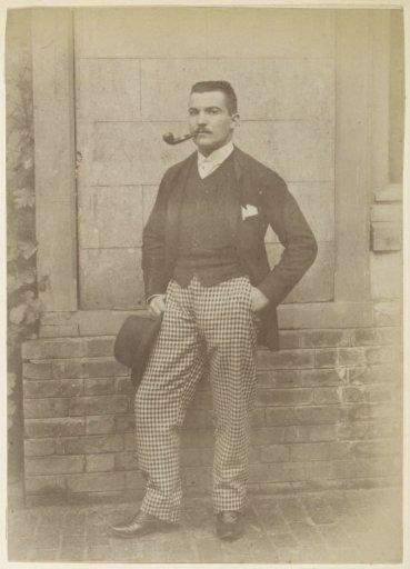 Portrait of a standing French man with a pipe, a hat and checkered trousers