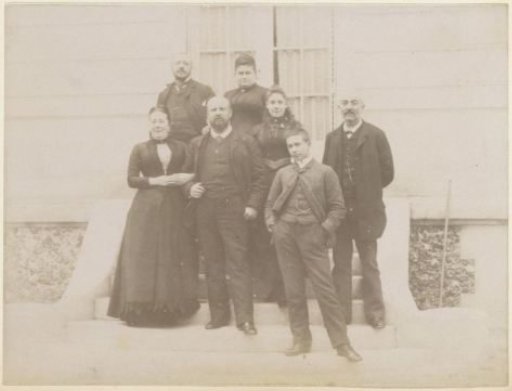Group portrait of a French family on the steps in front of a house