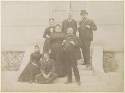 Group portrait of a French family on the steps in front of a house