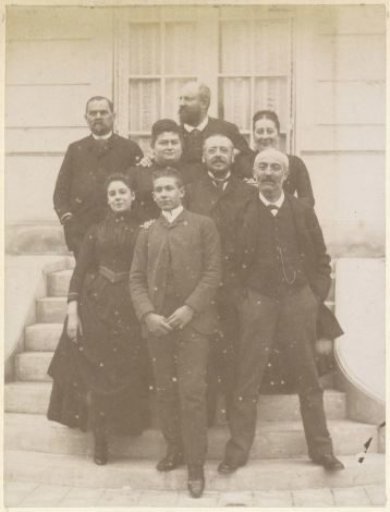 Group portrait of a French family on the steps in front of a house