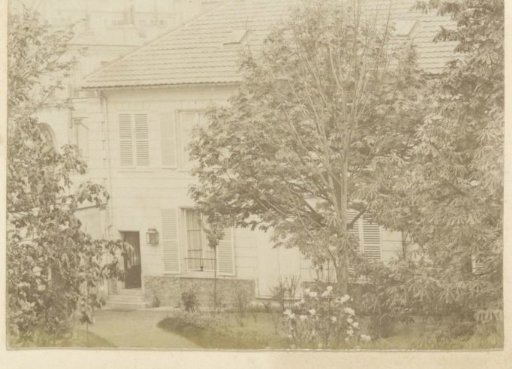 View of the facade of a house with a garden in France