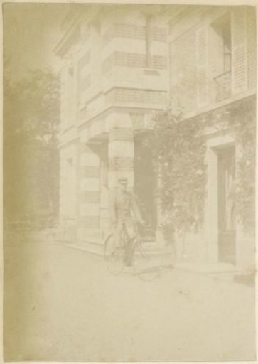 Cyclist in uniform in front of a house in France