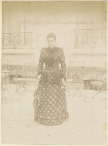 Portrait of a French woman in a dress with floral pattern and matching jacket