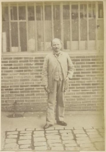 Portrait of a man in a short overcoat, possibly an employee of distillery Delizy & Doisteau in Pantin