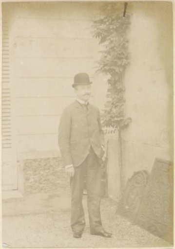 Portrait of a French man with a bowler hat and cigarette, standing