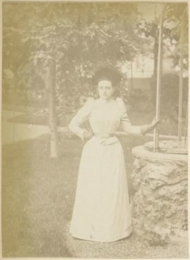 Portrait of a French woman standing by a well