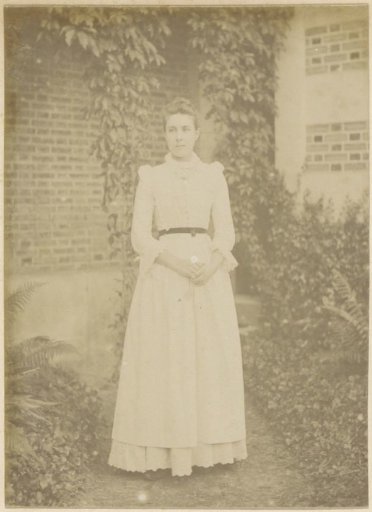 Portrait of a French woman standing in a garden
