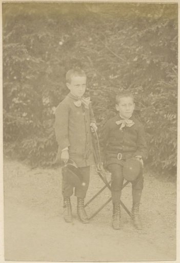 Portrait of two French boys, one standing, the other seated on a chair