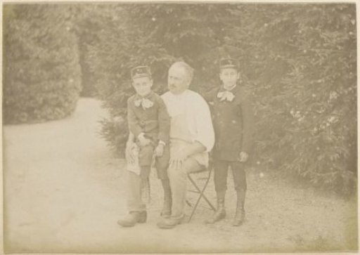 Portrait of a man and two boys in a garden in France