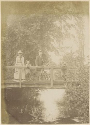 Family with three children on a wooden bridge in France