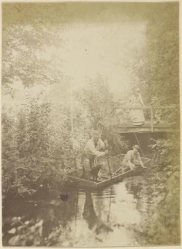 Men in a rowing boat with fish traps in a ditch in France