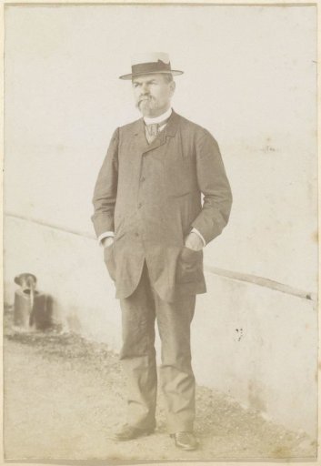 Portrait of a French man, standing with both hands in his pockets