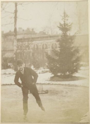 Man with a bowler hat skating on a pond near a villa in France