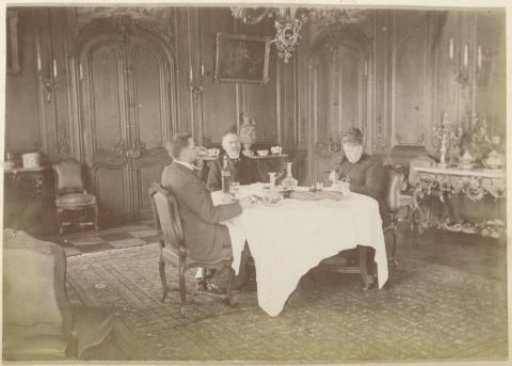 Interior of a room with three dining persons in France