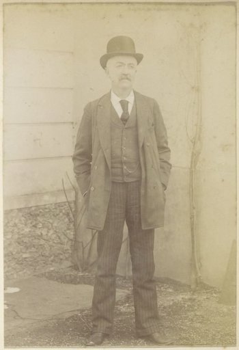 Portrait of a French man with a round hat and both hands in his pockets