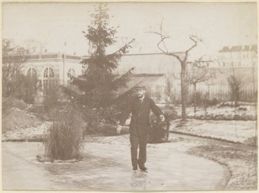 Man skating on a pond near an orangery in France