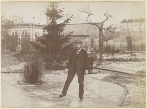 Man skating on a pond near an orangery in France
