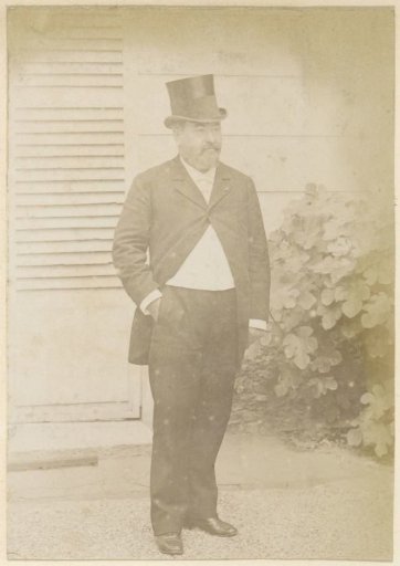 Portrait of a French man with a tall hat, standing with a hand in his pocket