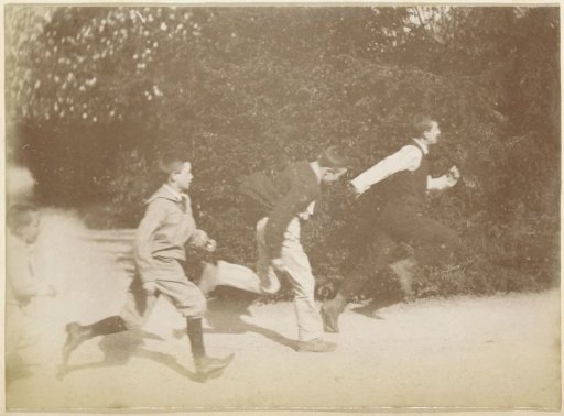 Four French boys running along a garden path in France