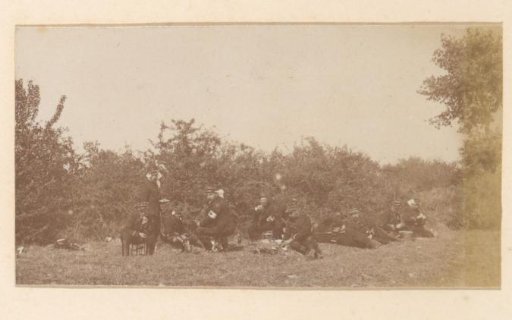 Group of soldiers dining on a grassy field in France