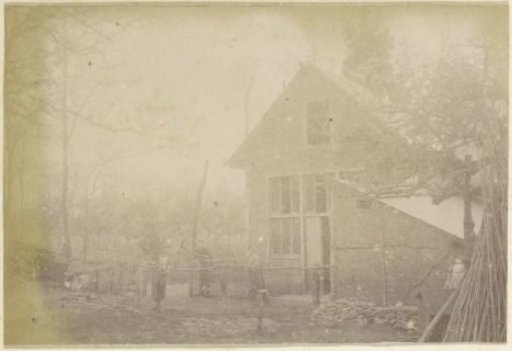Man, woman and child on a farmyard at a house in France