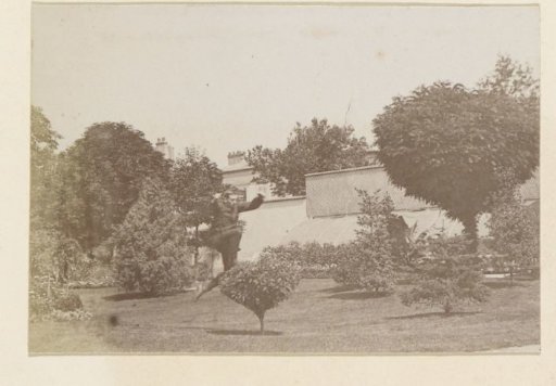 Man jumping over a bush in a garden in France
