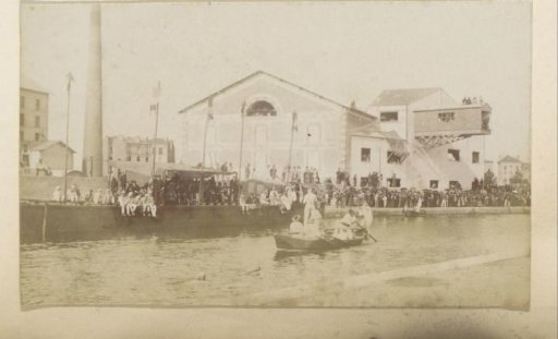 People on a quay at a factory in France