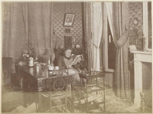 Reading woman, seated in a living room in France