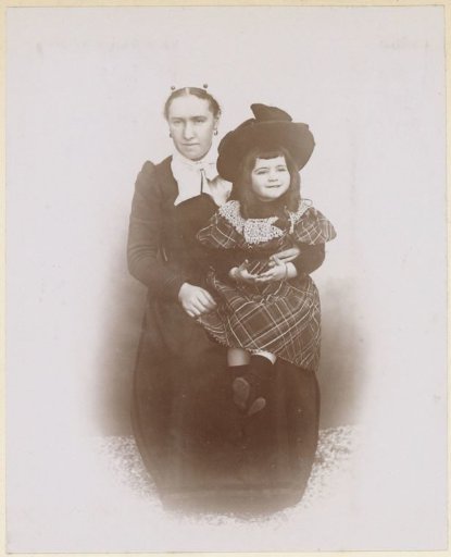 Portrait of a French woman with a child in a checkered dress on her lap