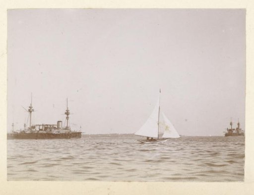 Sailing boat and warships off the coast of Southern France