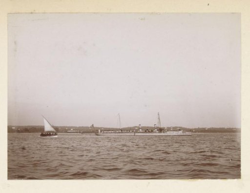Sailing boat and warship off the coast of Southern France