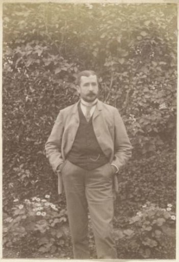 Portrait of a Man Standing by a Hedge in France