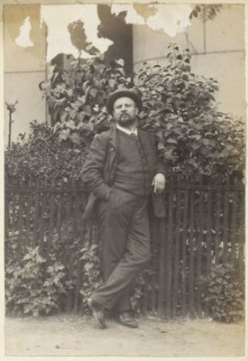 Portrait of a Man Standing by a Gate in France
