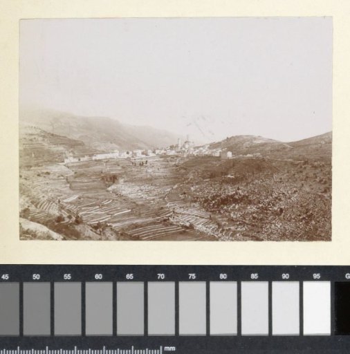 View of a mountain with terraces and a village, probably on the coast of southern France