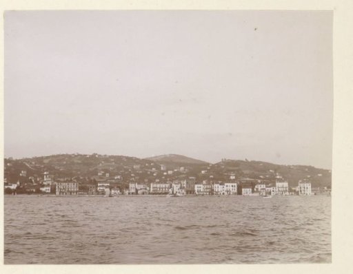 Houses on a coast seen across the water, probably in southern France
